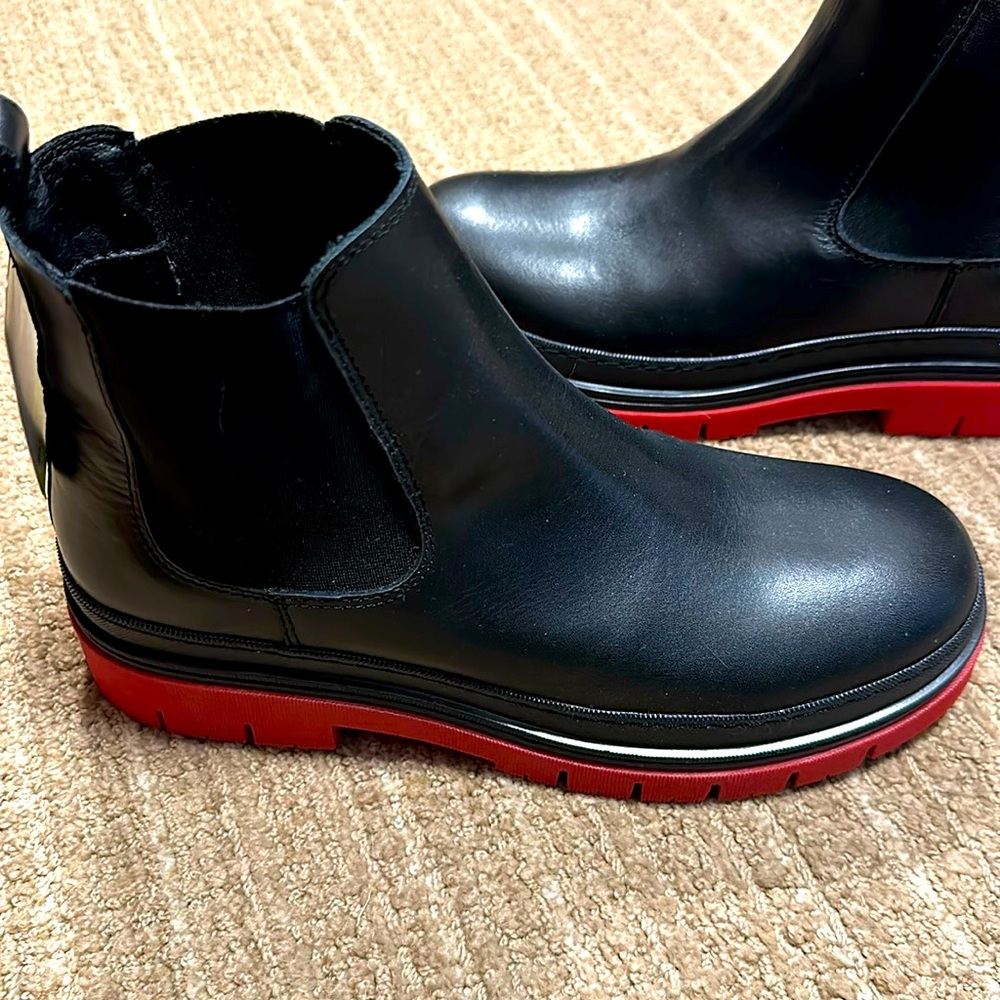 Stylish leather boots with red bottoms